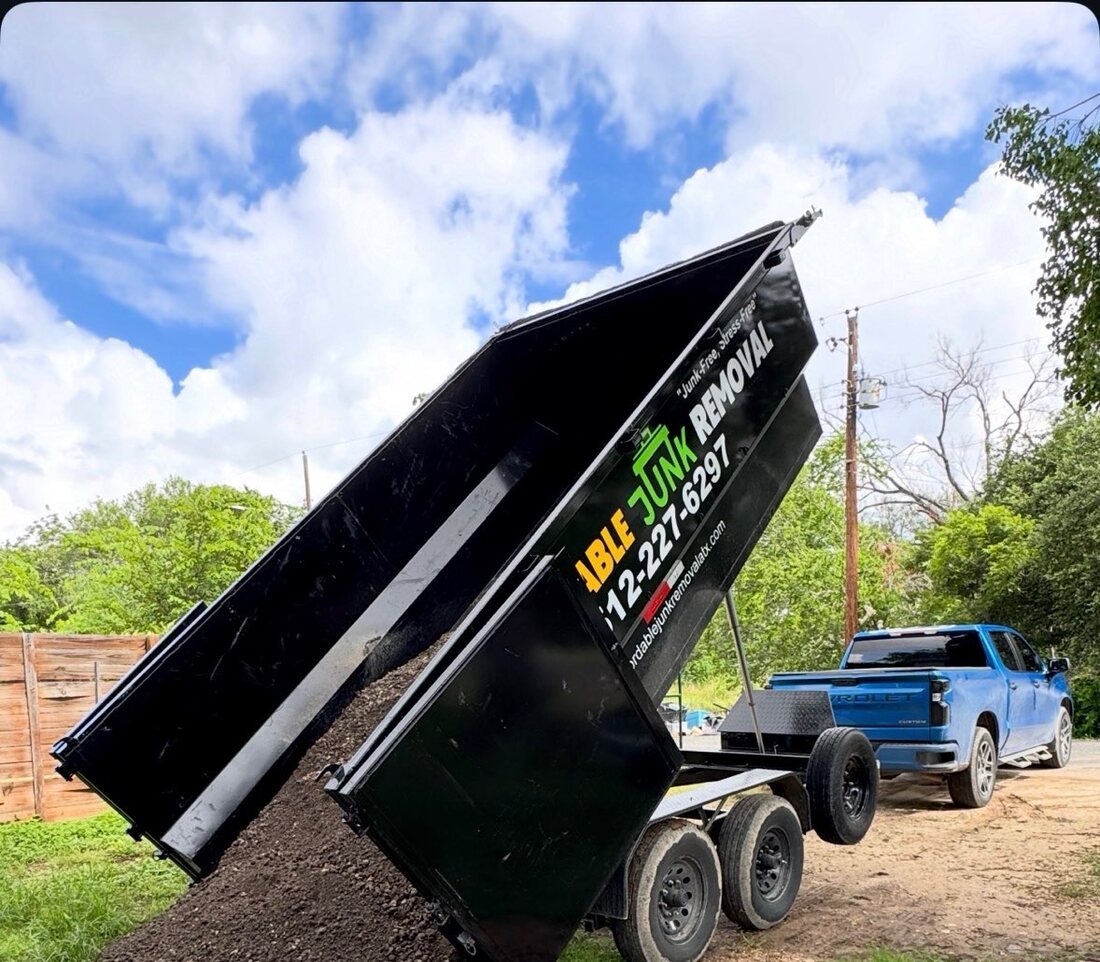 Affordable Junk Removal dump trailer delivering a load of dirt and mulch in Austin, TX